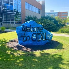 A boulder on ODU's main campus with a blue paint scheme and the message "Welcome to ODU!"