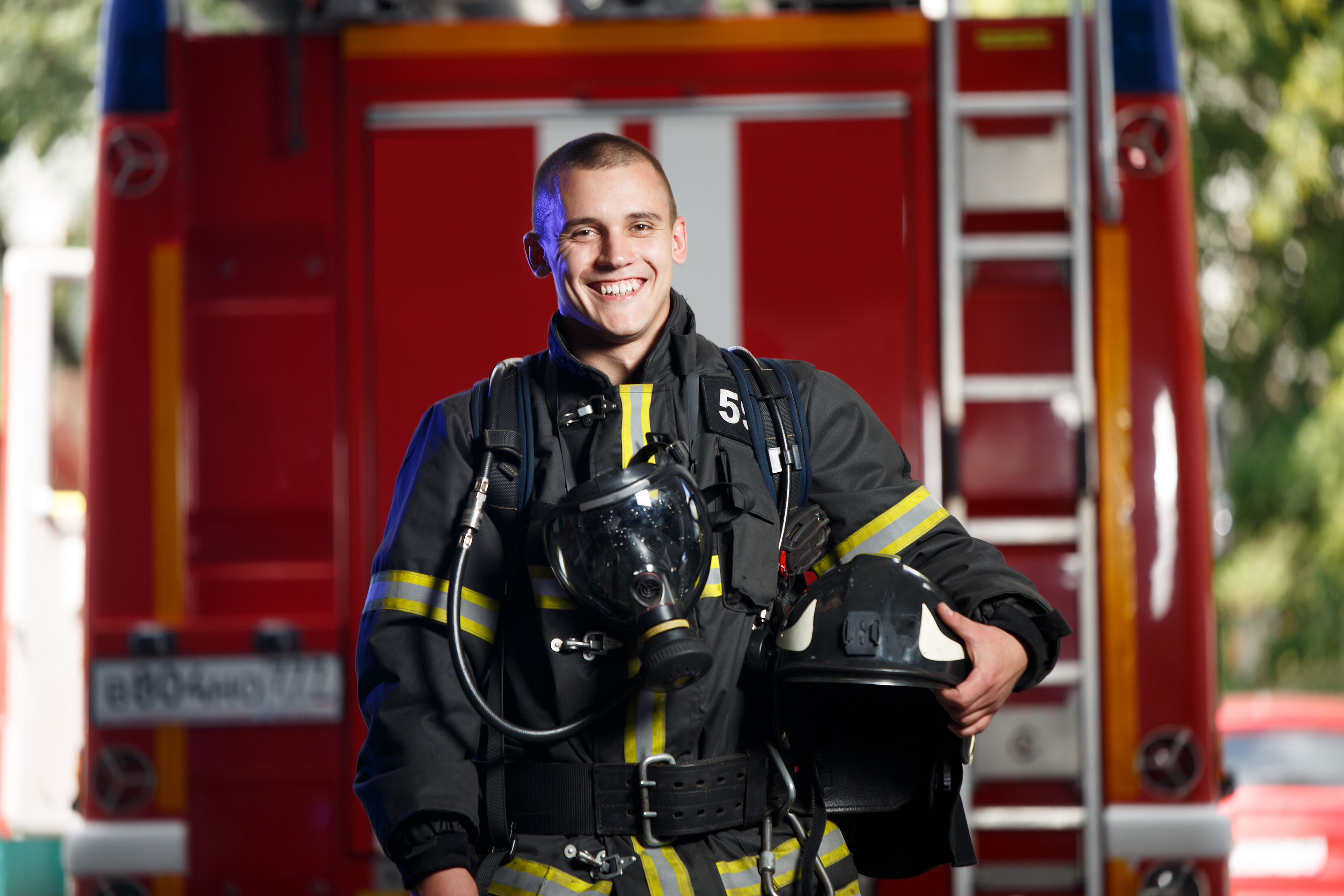 Firefighter holding his helmet