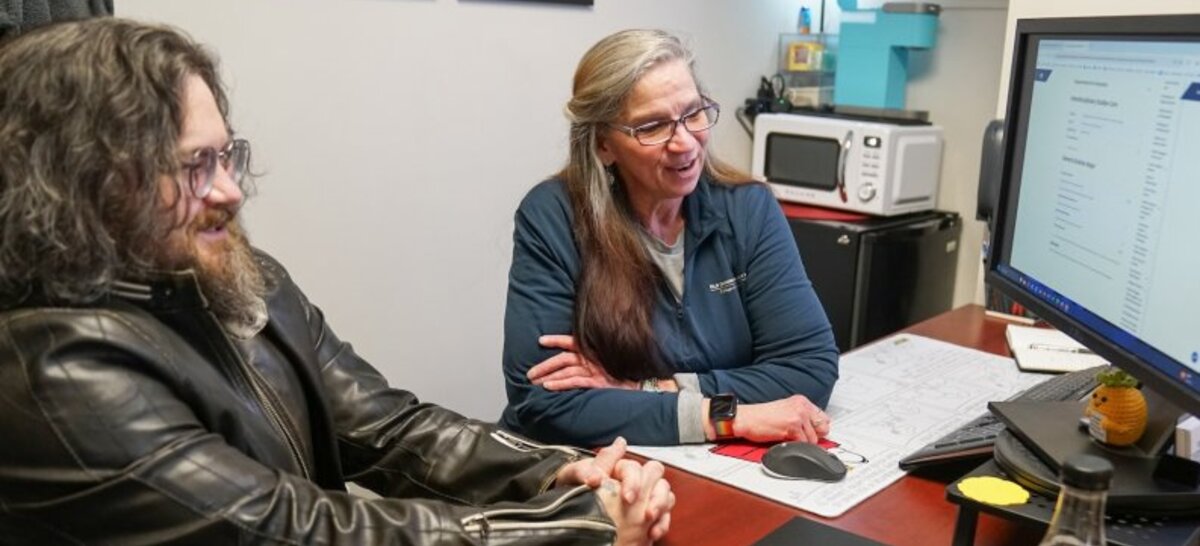John Bush, left, served in the Navy before returning to college. He had accumulated college credit at three other institutions before enrolling at Old Dominion University as a general studies major. He plans to graduate in spring 2026. Speaking with him is Academic Advisor Deb Kirkland. 
