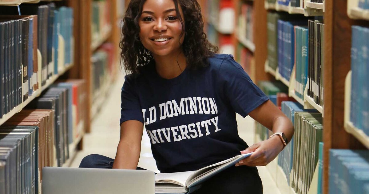 Smiling Old Dominion University student studying in library