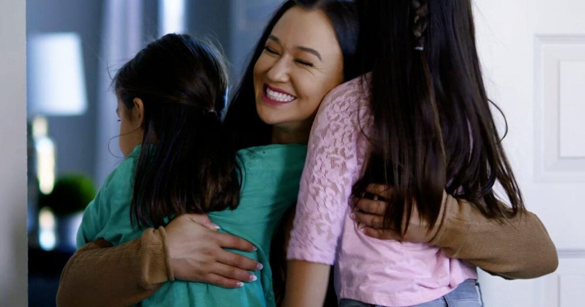 Screenshot of a Telly Award winning ODUOnline commercial. A mother hugs her two children in celebration. 