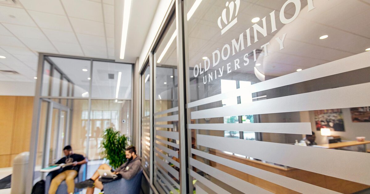 Old Dominion University logo on a glass window, with students seated and studying in the background.
