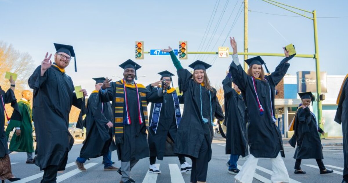 ODU Commencement, students walking across Hampton Blvd. on their way to commencement exercises