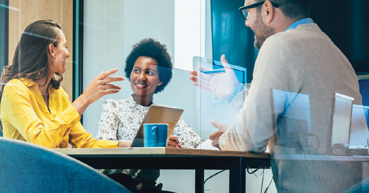 Business meeting in a conference room with multiple people.