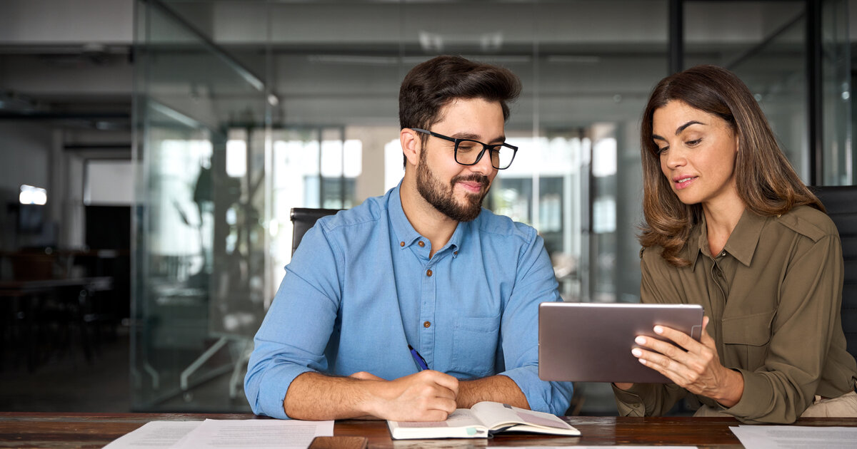 Peers observe marketing details on a tablet together