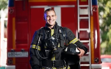Firefighter holding his helmet