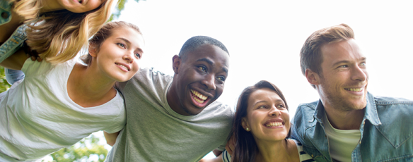 Group of friends at the park, smiling and laughing