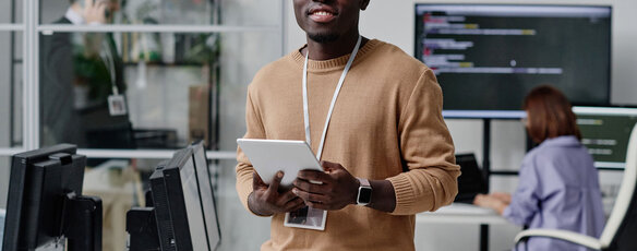 IT specialist working online on digital tablet