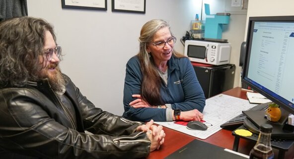 John Bush, left, served in the Navy before returning to college. He had accumulated college credit at three other institutions before enrolling at Old Dominion University as a general studies major. He plans to graduate in spring 2026. Speaking with him is Academic Advisor Deb Kirkland. 