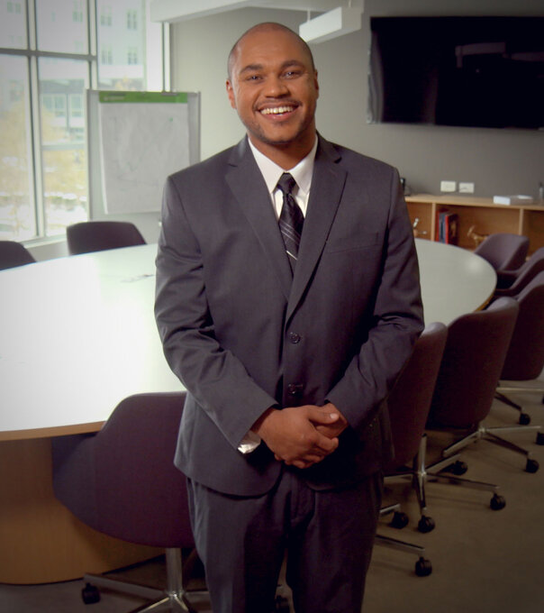 Happy professional man in board room 