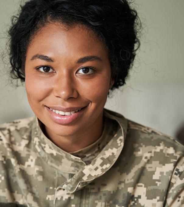 Woman in military fatigues facing the camera