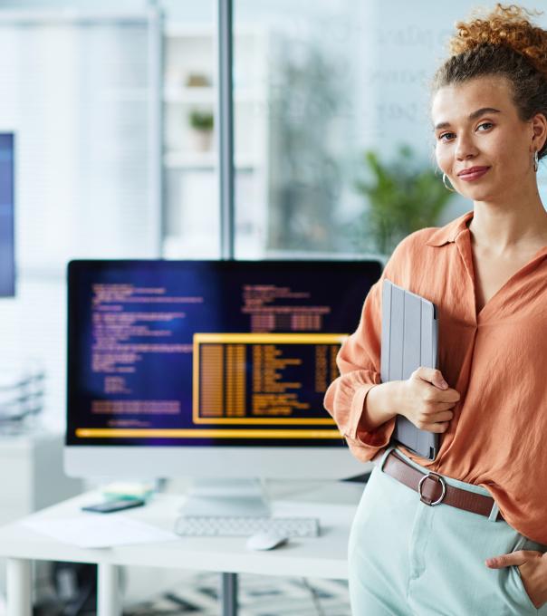 Programmer smiling in front of her computer