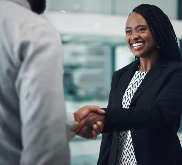 Person shaking hands with a client in a business meeting