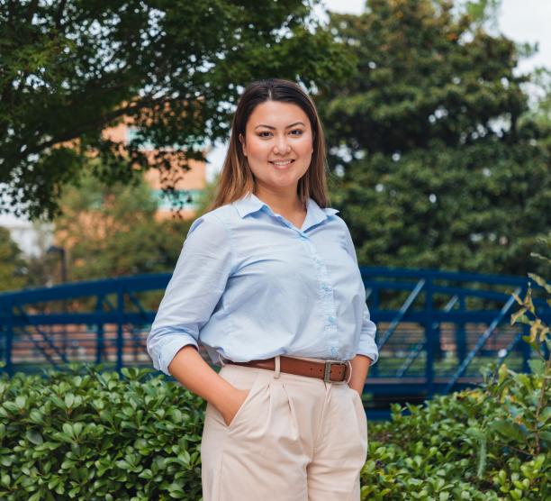 Student stands in front of Gornto Hall the home of ODUGlobal's headquarters.