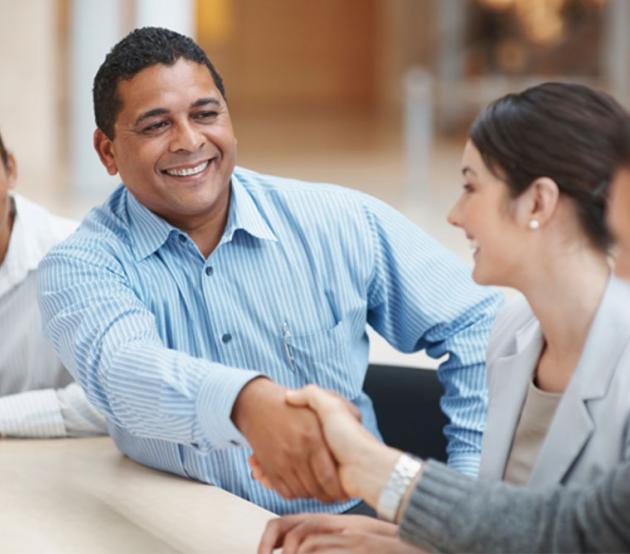 Business professionals shaking hands in agreement