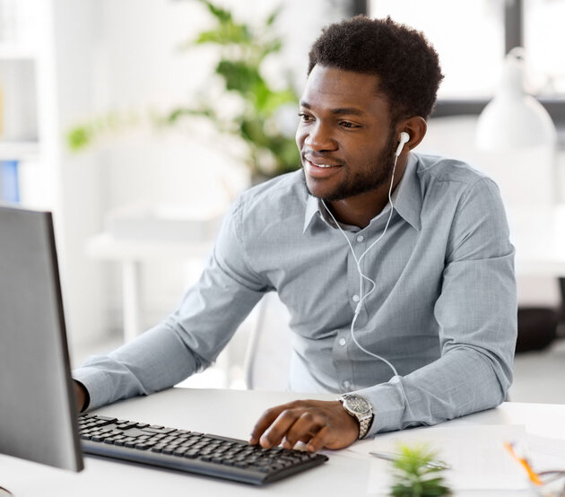 Young man wearing headphones studying online