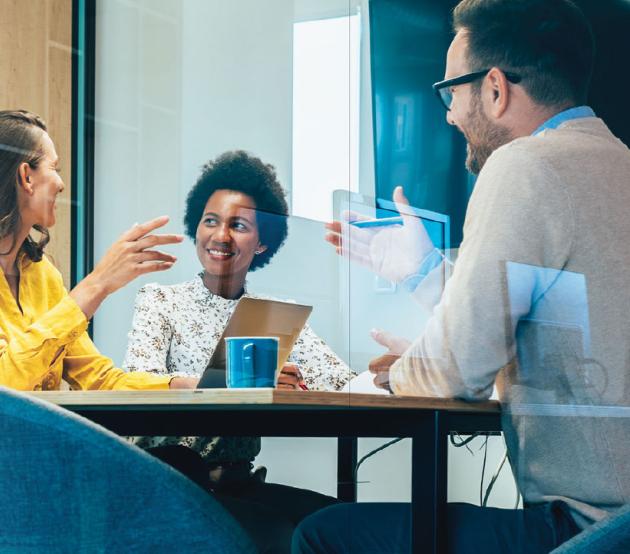 Business meeting in a conference room with multiple people.