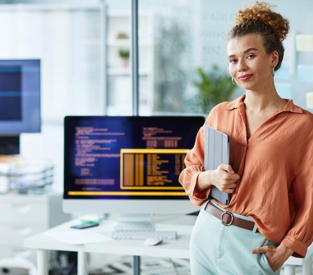 Programmer smiling in front of her computer