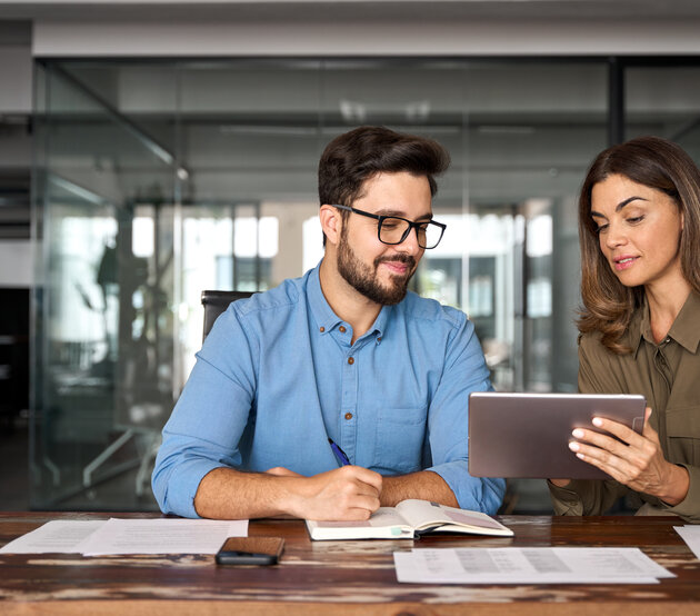 Peers observe marketing details on a tablet together
