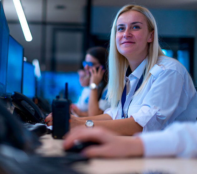 A female forensic data analyst works at a computer 