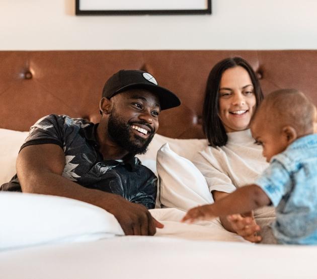 A ODUGlobal family sits together playing with their toddler