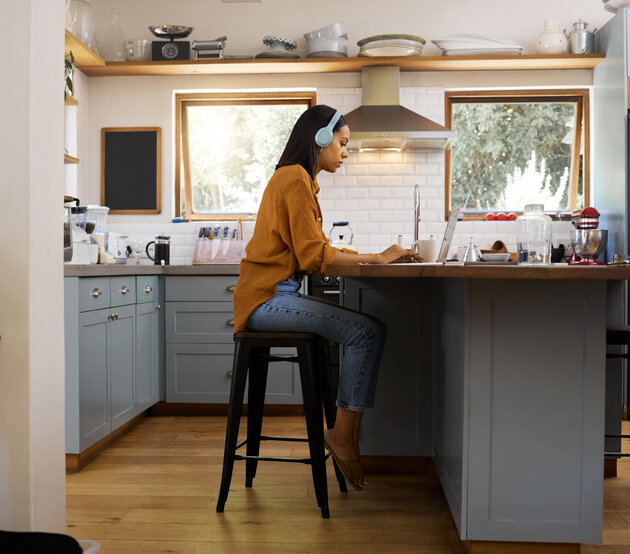 Student looking at laptop on kitchen counter