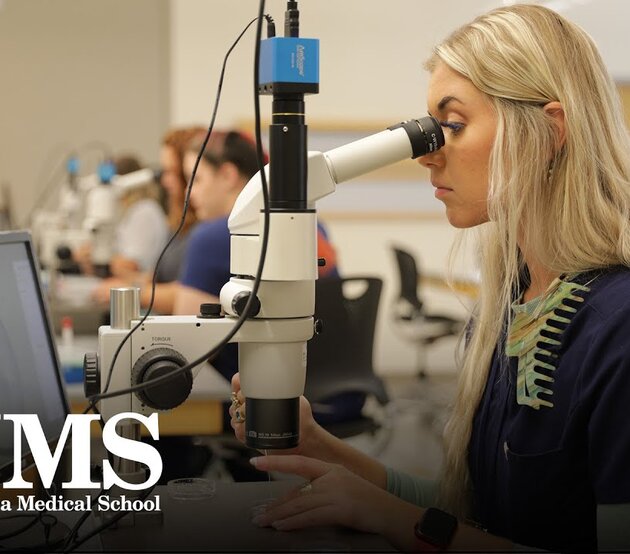 Woman looking into a microscope