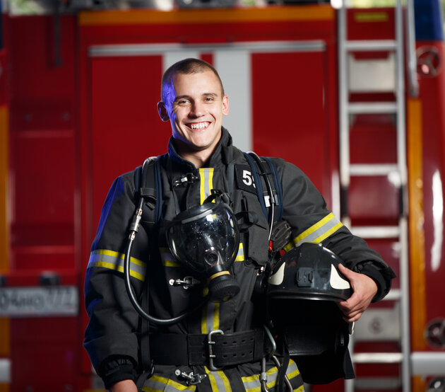 Firefighter holding his helmet
