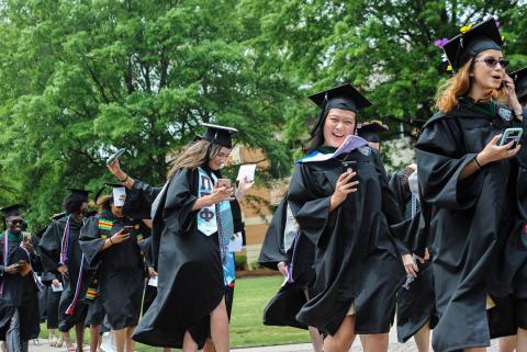 ODU graduates walk across the seal on commencement day