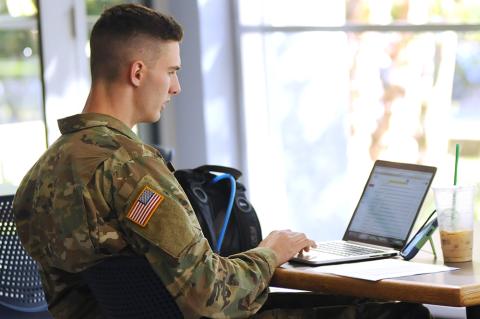 Military student on computer