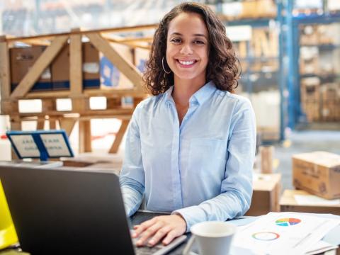 Photo of woman working in a warehouse environment in supply chain management