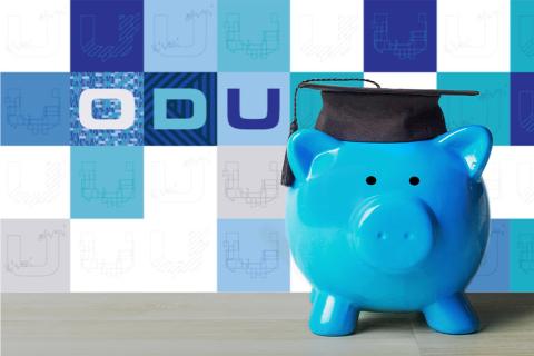 A blue ceramic piggy bank wears a college graduation cap to illustrate paying for college with scholarships.