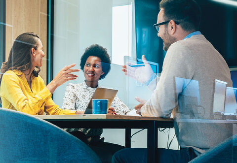 Business meeting in a conference room with multiple people.