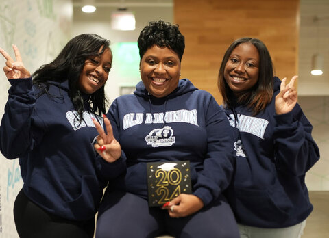 ODU alumnae Jordyn Harrell, left, and Jasmyn Harrell flank their mother Celeste Harrell, who is scheduled to graduate from ODU in May 2023.