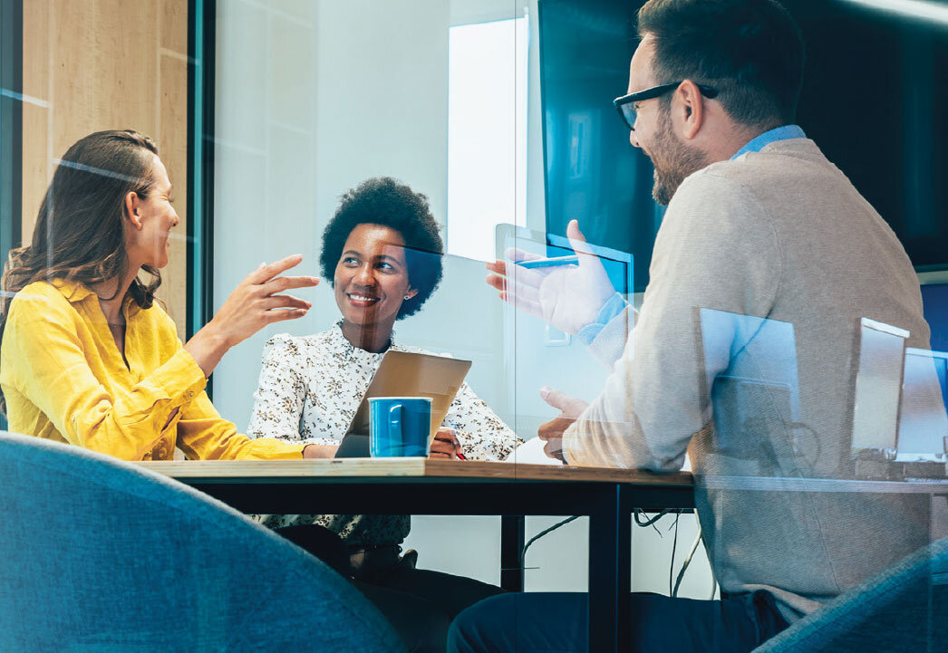 Business meeting in a conference room with multiple people.