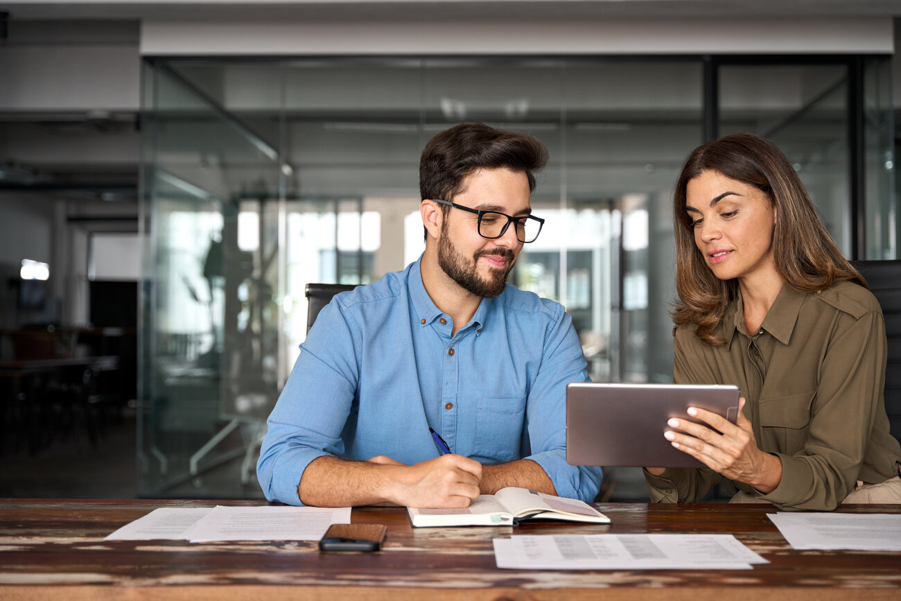 Peers observe marketing details on a tablet together