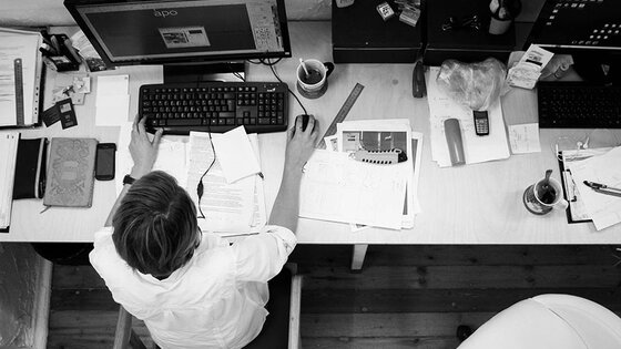 Overhead view of professional at desk with computer