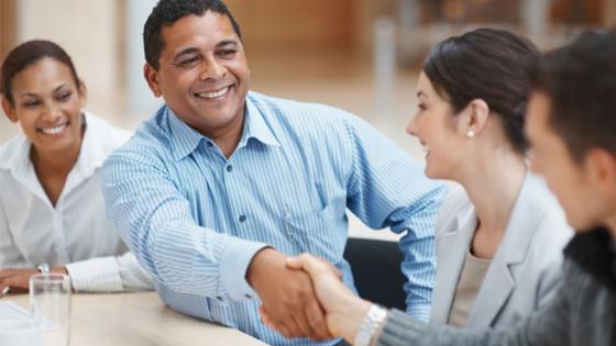 Business professionals shaking hands in agreement