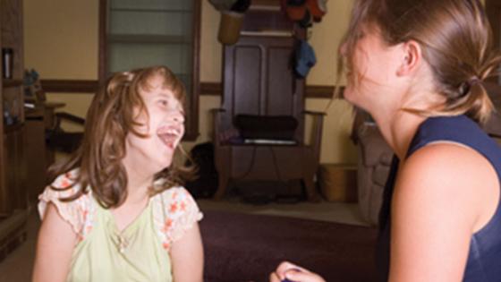 teacher laughing with child