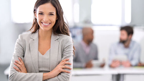 Smiling woman demonstrating leadership in a meeting