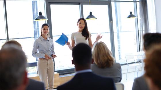 Workplace trainer talks to business professionals after learning occupational studies