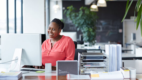 Woman working at desk in an open office