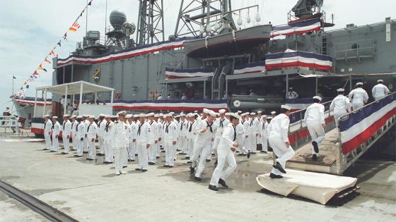 Sailors board the USS Elrod during its commissioning ceremony.