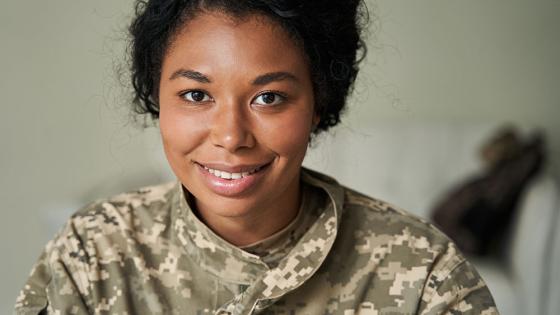 Woman in military fatigues facing the camera