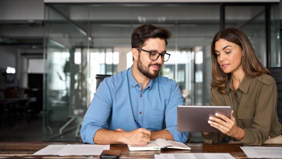 Peers observe marketing details on a tablet together