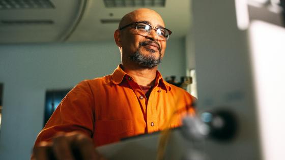 IT personnel standing at his workstation