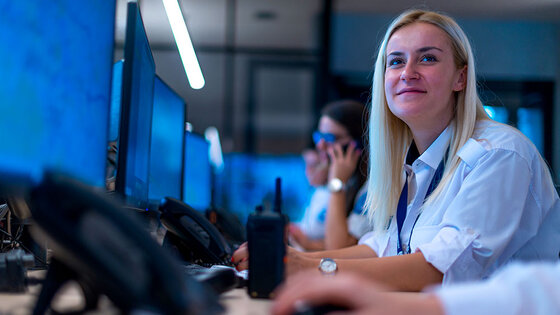 A female forensic data analyst works at a computer 