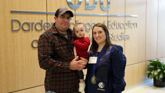 With her husband, Austin, and daughter, Elaine, Emily Collins ’25 marks the completion of Old Dominion University’s master’s in education with a math specialist concentration.