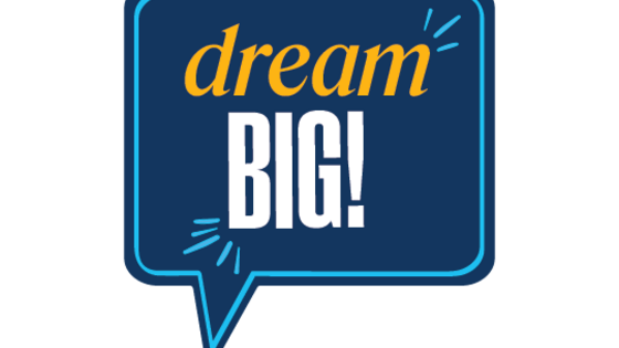 Dark blue speech photo prop reading "Dream Big!"