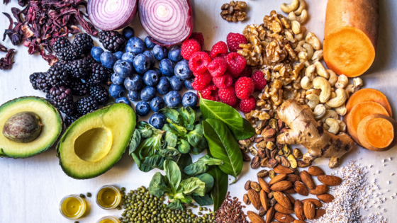 A table top of assorted fruits, vegetables and nuts.